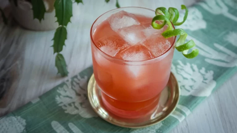 Blood Orange Margarita garnished with a spirally twist of lime