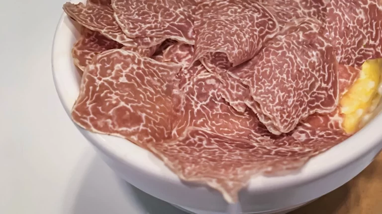 Shaved black truffles over a bowl of baked eggs at Ristorante All'Enoteca in Piemonte, Italy